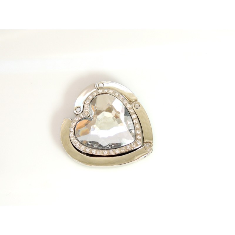 Porte sac en métal argenté articulé orné d'une pierre blanche facettée en forme de coeur