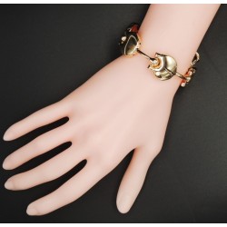 Bracelet design en paqué or, disques reliés par des tiges articulées